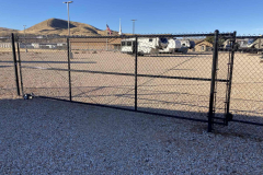 Large-electric-gate-in-black-chain-link-fence-installed-by-Robinson-Fencing