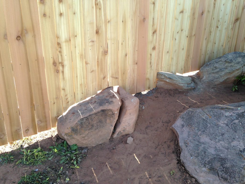 Wood privacy fence installed with rock landscaping in Cedar City Ut